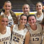 St. Aloysius girls' basketball team celebrating their season opening win with smiles and team jerseys.