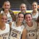 St. Aloysius girls' basketball team celebrating their season opening win with smiles and team jerseys.