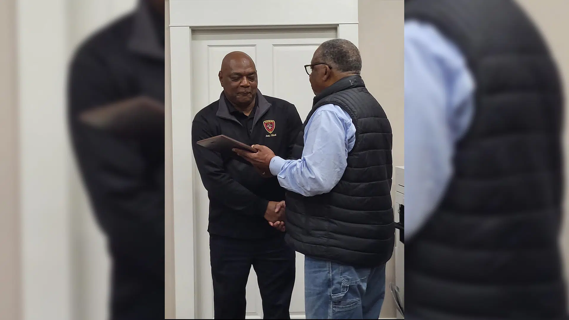 Carl Carson receives a plaque from Mayor George Flaggs honoring his retirement after 34 years of service.