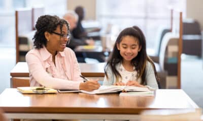 Elementary girl reads with adult