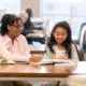 Elementary girl reads with adult