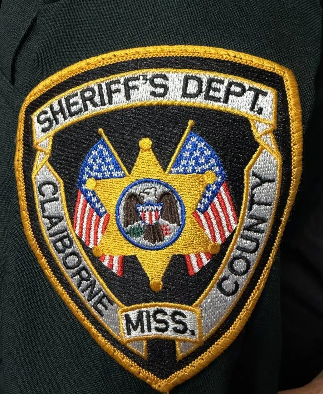 Embroidered patch of the Claiborne County Sheriff's Department featuring a star and American flags.