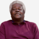 Smiling older man with gray hair wearing a maroon sweater, exuding warmth and contentment. — Roosevelt “Sonny” Jones Jr