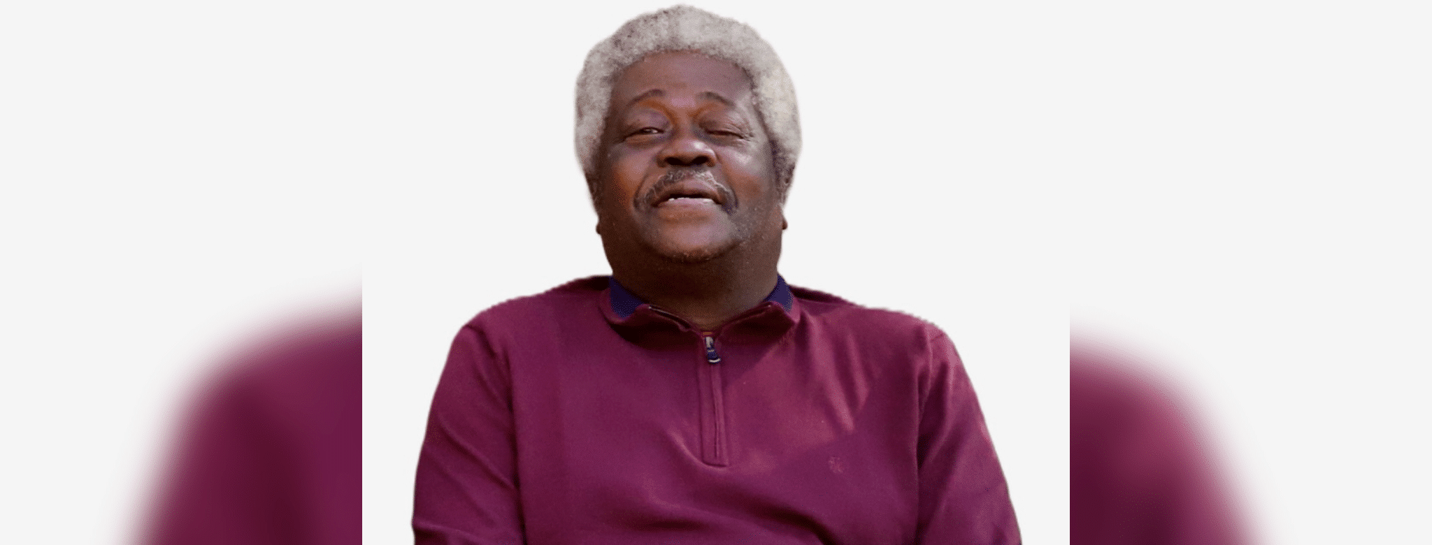 Smiling older man with gray hair wearing a maroon sweater, exuding warmth and contentment. — Roosevelt “Sonny” Jones Jr