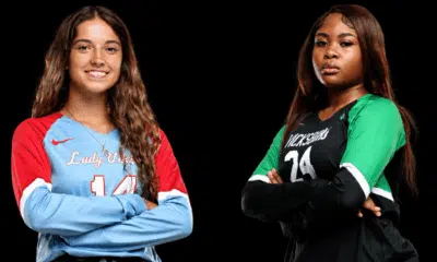 Two volleyball players, one in a blue and red jersey and the other — WC and VHS volleyball picked up road wins on Tuesday