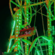 Brightly lit Ferris wheel at night, showcasing vibrant green lights at the Yazoo Fair.