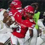 Warren Central player evades defenders during a rainy football g — Warren Central rolls past Pearl 40-14 to improve to 2-0