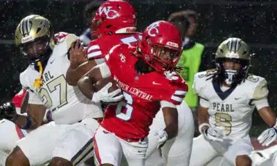 Warren Central player evades defenders during a rainy football g — Warren Central rolls past Pearl 40-14 to improve to 2-0