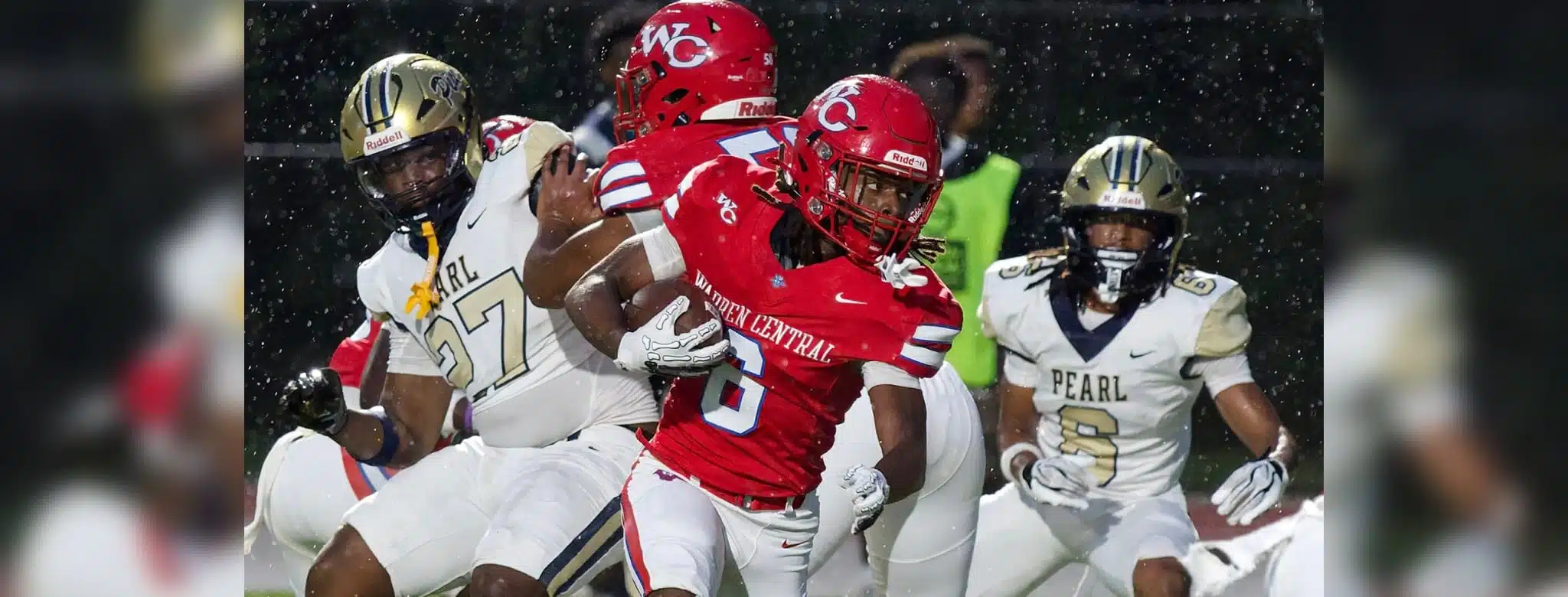 Warren Central player evades defenders during a rainy football g — Warren Central rolls past Pearl 40-14 to improve to 2-0