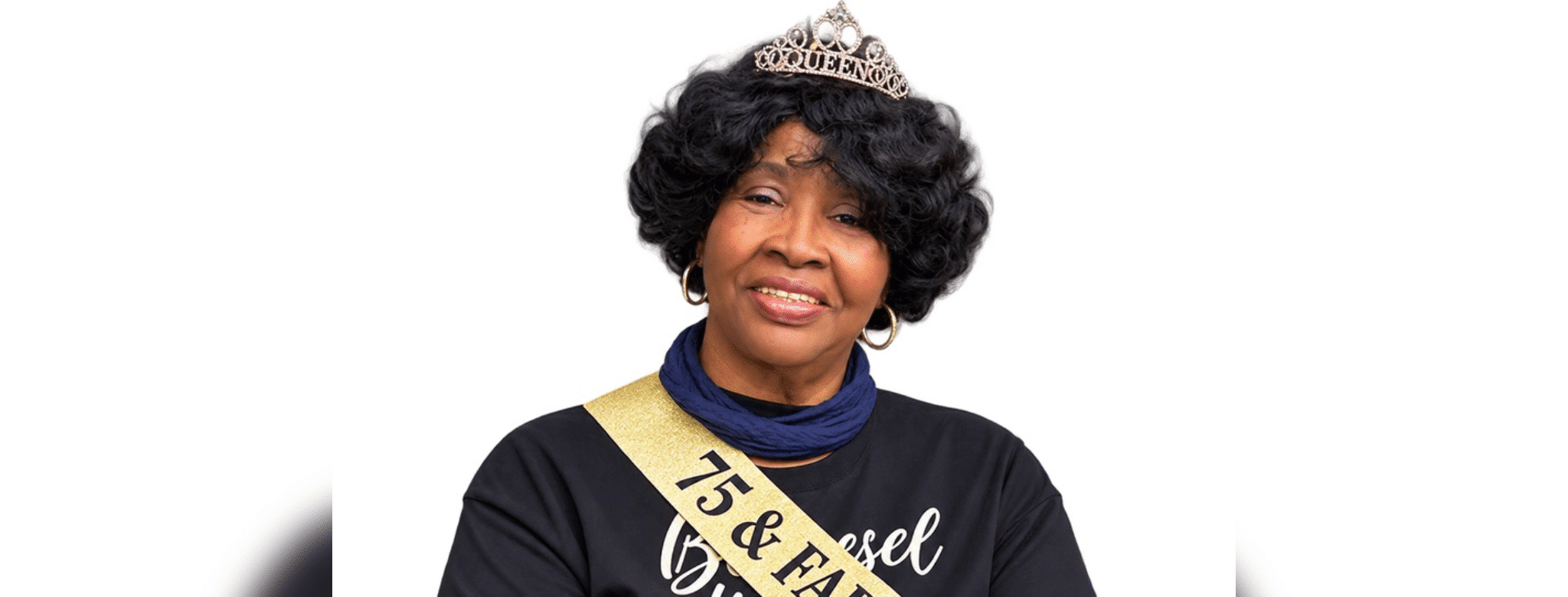 A woman wearing a tiara and sash celebrating her 75th birthday, smiling warmly. — Roberta Anderson