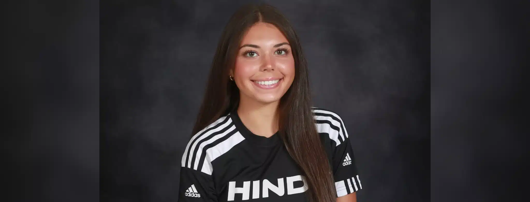Jordan Polk, a soccer player in a Hinds Community College jersey, smiles for the camera.