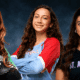 Three volleyball players from Vicksburg, Warren Central, and St. Aloysius pose confidently in their team jerseys.