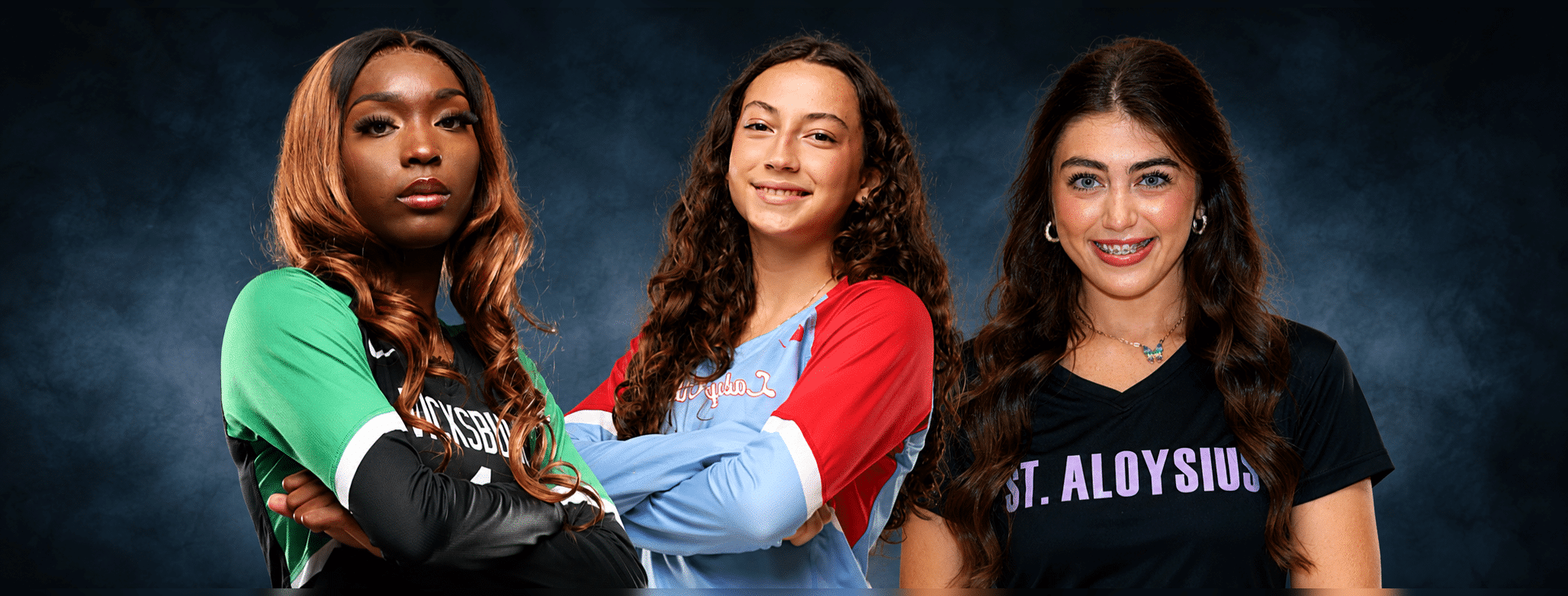 Three volleyball players from Vicksburg, Warren Central, and St. Aloysius pose confidently in their team jerseys.
