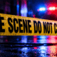 Police tape reading 'CRIME SCENE DO NOT CROSS' at a wet scene with emergency — Teenager shot in Vicksburg on Friday night