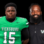Vicksburg High School football player in green jersey and coach in black shirt, both posing for a photo. — Gators 35-0