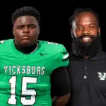 Vicksburg High School football player in green jersey and coach in black shirt, both posing for a photo. — Gators 35-0