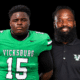 Vicksburg High School football player in green jersey and coach in black shirt, both posing for a photo. — Gators 35-0