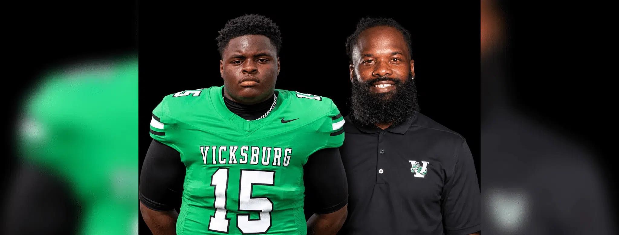 Vicksburg High School football player in green jersey and coach in black shirt, both posing for a photo. — Gators 35-0