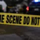 Yellow crime scene tape reading 'CRIME SCENE DO NOT CROSS' at a police investigation site. — Capital murder — custody