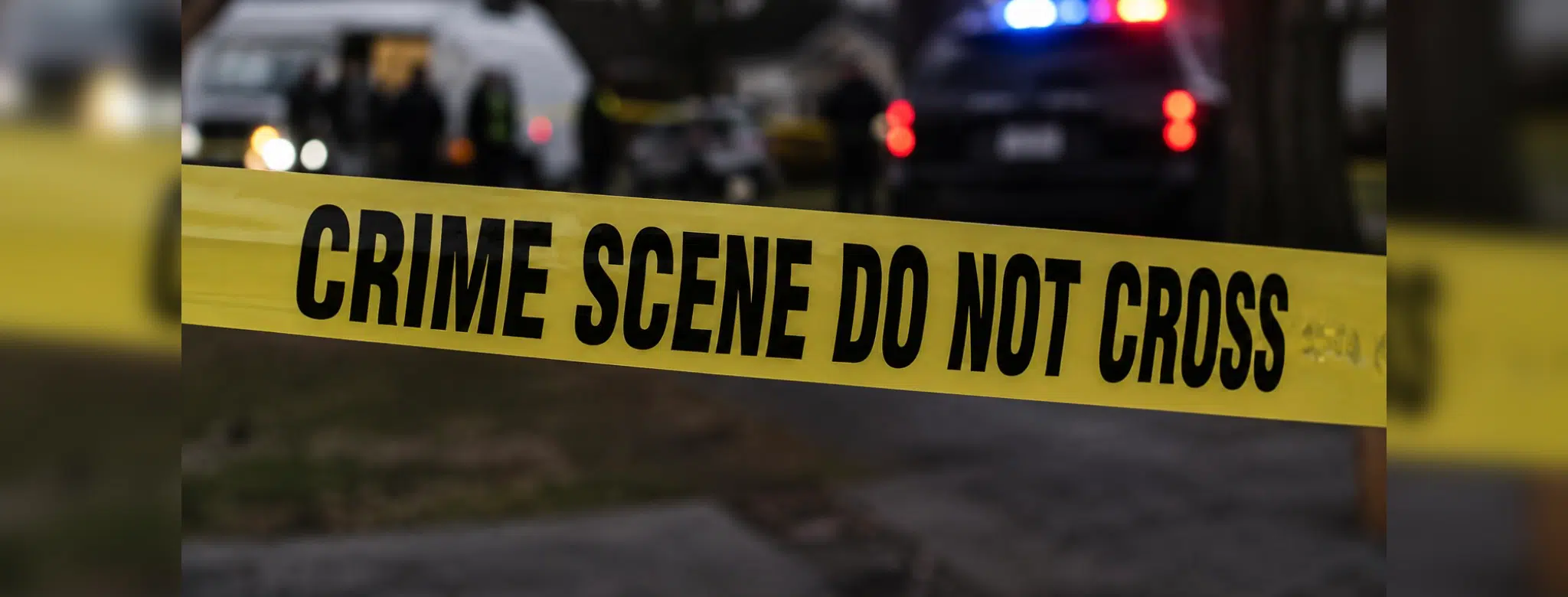 Yellow crime scene tape reading 'CRIME SCENE DO NOT CROSS' at a police investigation site. — Capital murder — custody