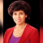 Portrait of Vicki Roach Barnes, a distinguished judge, wearing a red blazer and pearls.