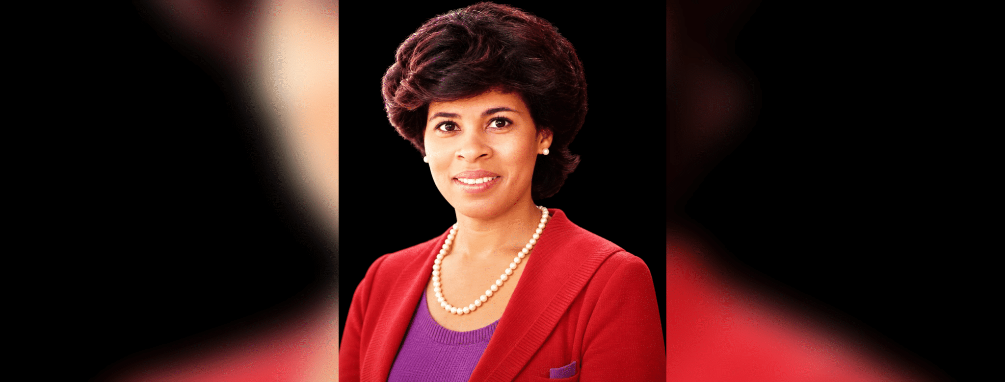 Portrait of Vicki Roach Barnes, a distinguished judge, wearing a red blazer and pearls.