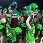 VJHS football team celebrating with helmets raised after a victory against Germantown. — VJHS crushed Germantown 38-16