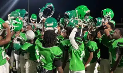 VJHS football team celebrating with helmets raised after a victory against Germantown. — VJHS crushed Germantown 38-16