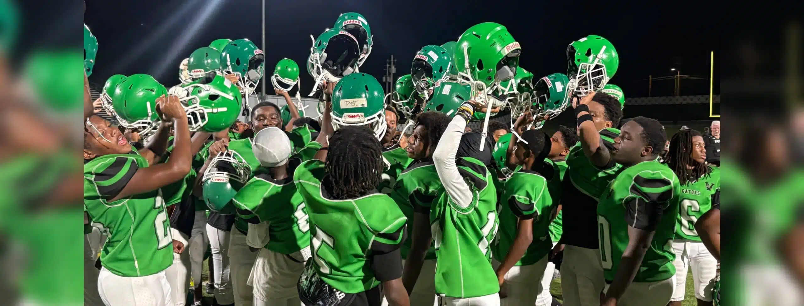 VJHS football team celebrating with helmets raised after a victory against Germantown. — VJHS crushed Germantown 38-16