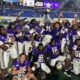Alcorn football team celebrates victory at the Southern Heritage Classic, holding a trophy and posing for the camera.