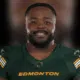 Nick Anderson smiling in Edmonton Elks uniform, showcasing his leadership in football.