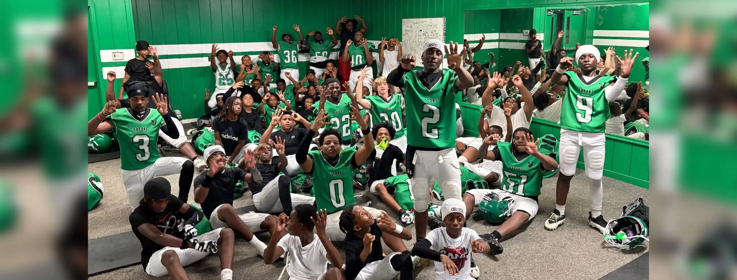 VJHS football team celebrating in locker room after their 4-0 victory, showing team spirit and exci — VJHS improves to 4-0