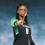 A Vicksburg High School volleyball player in a black jersey points confidently at the came — VHS volleyball defeats Canton