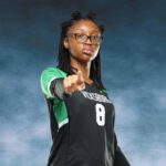A Vicksburg High School volleyball player in a black jersey points confidently at the came — VHS volleyball defeats Canton