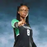 A Vicksburg High School volleyball player in a black jersey points confidently at the came — VHS volleyball defeats Canton