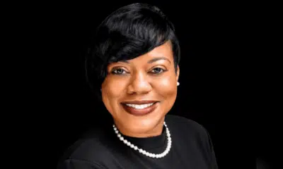 Rashandra Laws, a nurse practitioner, smiling in a professional setting with a black background.
