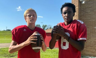 Two young football players in red jerseys, one holdin — Morgan throws three touchdowns; Miles scores four in WCJHS victory