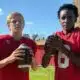 Two young football players in red jerseys, one holdin — Morgan throws three touchdowns; Miles scores four in WCJHS victory