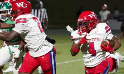 Warren Central football players in red uniforms during a game against Vicksburg High, showcasing action on the fiel — 15th