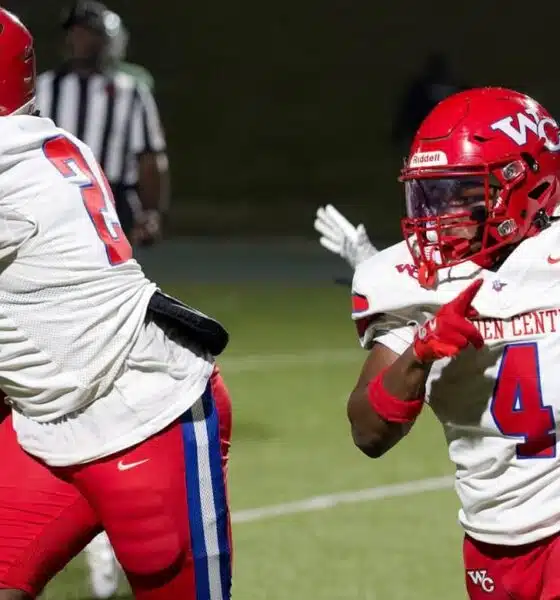 Warren Central football players in red uniforms during a game against Vicksburg High, showcasing action on the fiel — 15th