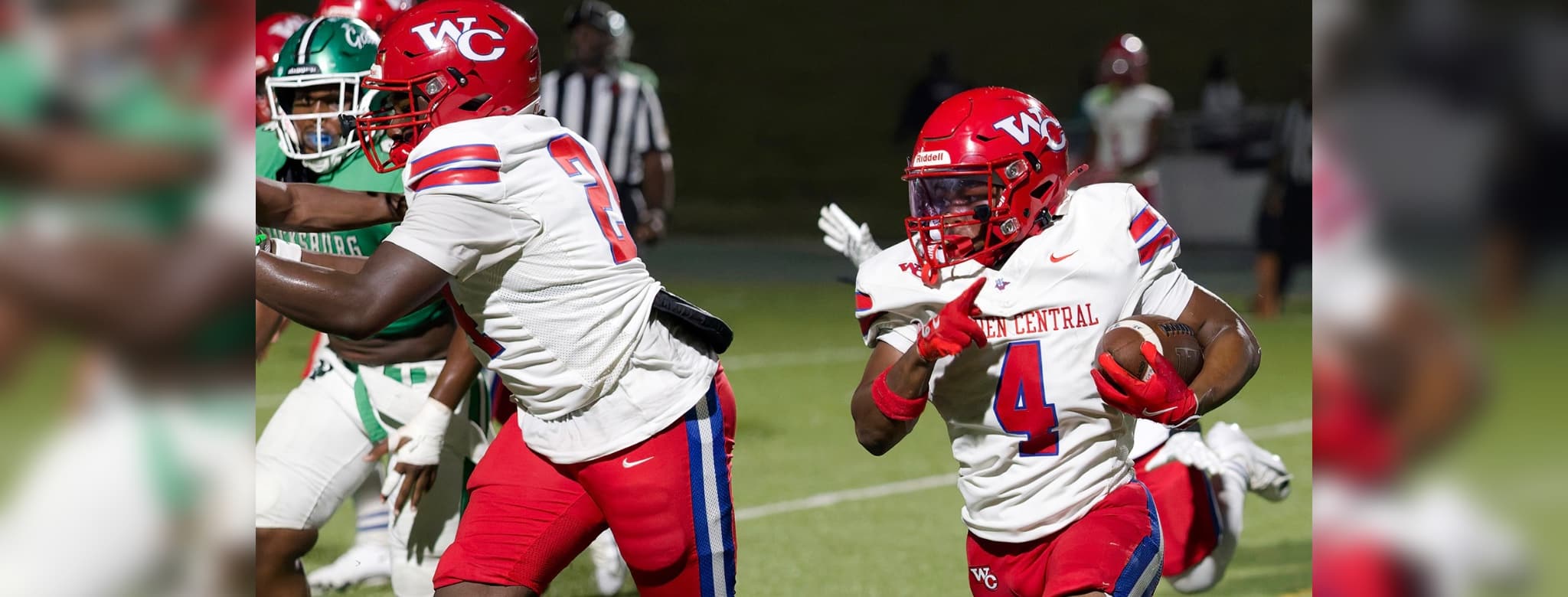 Warren Central football players in red uniforms during a game against Vicksburg High, showcasing action on the fiel — 15th