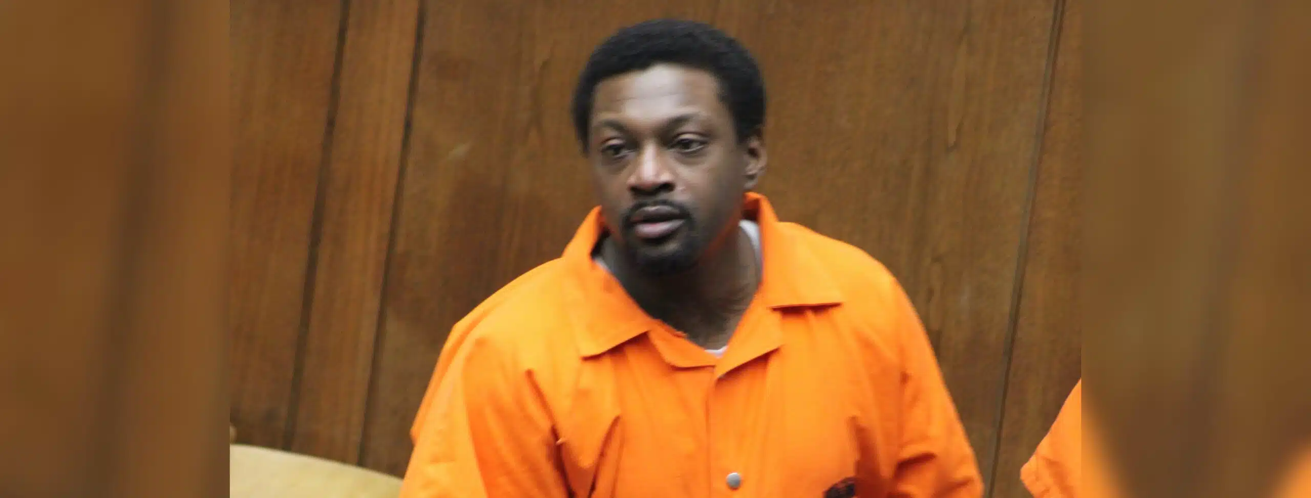A man in an orange jumpsuit appears in a courtroom setting, looking serious. — $5 million