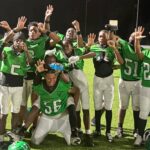 Vicksburg Junior High School football team celebrating after their victory, wearing green jerseys and posing — Little Six