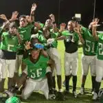 Vicksburg Junior High School football team celebrating after their victory, wearing green jerseys and posing — Little Six