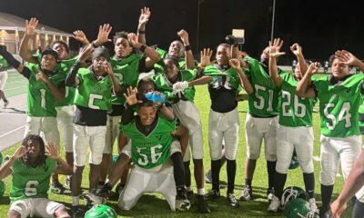 Vicksburg Junior High School football team celebrating after their victory, wearing green jerseys and posing — Little Six