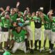 Vicksburg Junior High School football team celebrating after their victory, wearing green jerseys and posing — Little Six