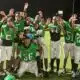 Vicksburg Junior High School football team celebrating after their victory, wearing green jerseys and posing — Little Six