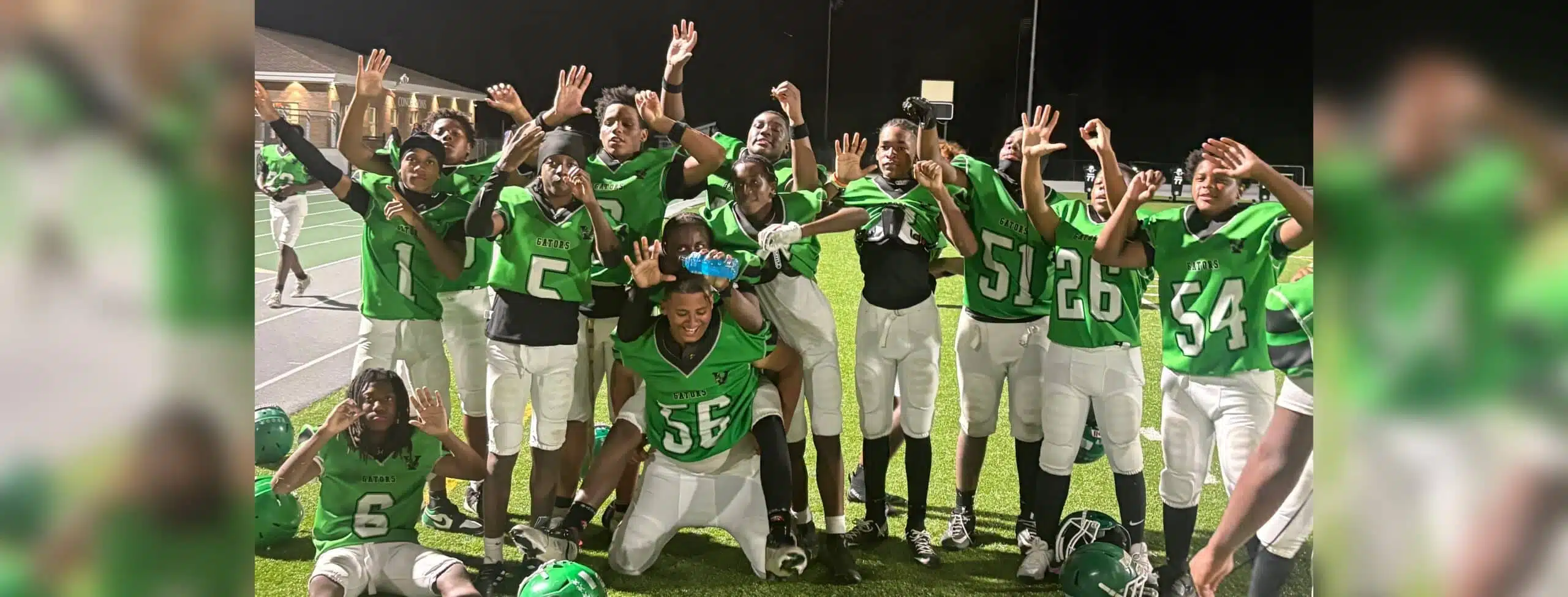 Vicksburg Junior High School football team celebrating after their victory, wearing green jerseys and posing — Little Six
