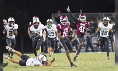 Hinds CC football player running with the ball while defenders chase during a game, celebrating a touchdown. — 52-28