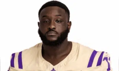 Shardez Taylor in a football uniform, looking serious and confident.